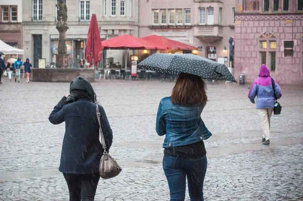 Портрет женщины с зонтиком на булыжнике в городе — стоковое фото