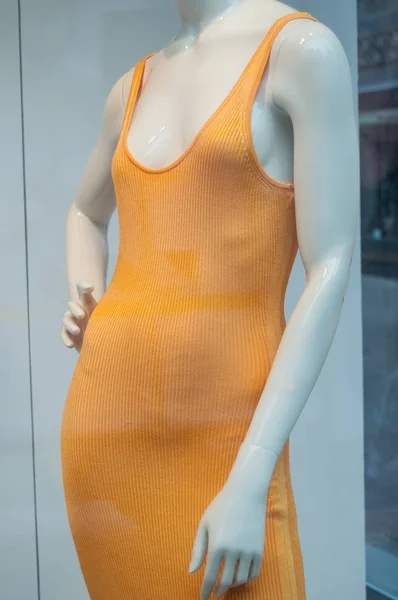 Vestido naranja delgado en una tienda de moda para mujeres —  Fotos de Stock