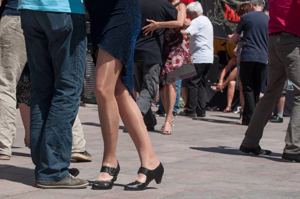 couples of tango dancers on main place with other dancers at the spring tango festival
