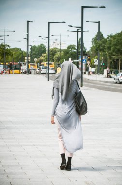 Sokakta yürürken örtülü Müslüman kadın 