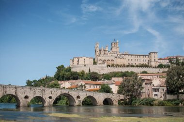 panorama of old roman bridge and cathedral St Nazaire in Beziers clipart