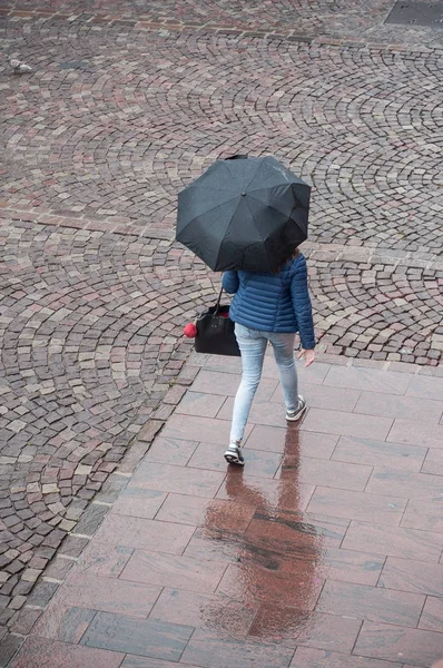 Žena s deštníkem na dláždění místo ve městě — Stock fotografie