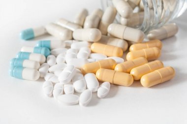  kapsül ve şişeden whit üzerinde düşen ilaç tablet