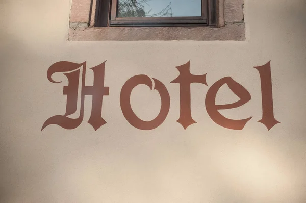 Hotelschild an Steinmauer — Stockfoto