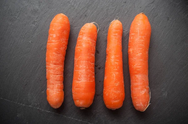 Carrots alignment on chalkboard background — Stock Photo, Image