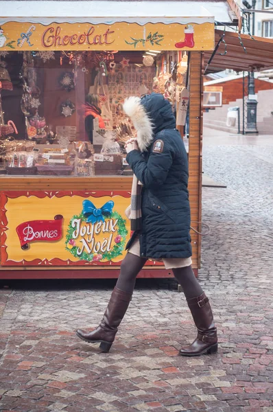 Mujer con abrigo de invierno caminando frente a la tienda de especias de pan en el mercado de Navidad —  Fotos de Stock