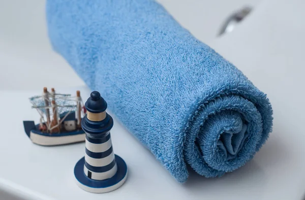 Blue rolled bath towel with ocean decoration — Stock Photo, Image