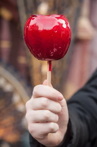 Hand of woman with sweet  candy red apple at the chri — Stock Photo, Image