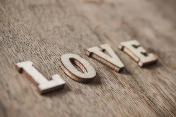 Koncept dřevěné slovo na dřevěný stůl - láska — Stock fotografie