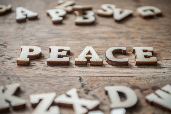 Concepto de letras de madera sobre fondo de mesa de madera - Paz — Foto de Stock