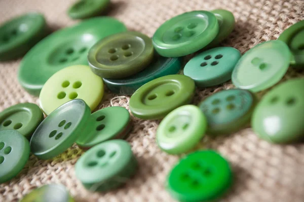 Зелені швейні гудзики на фоні ваянської текстури — стокове фото
