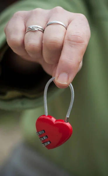 Woman giving padlock in shaped heart — Stock Photo, Image