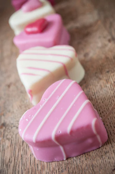 pink shaped heart pastry alignment on wooden table