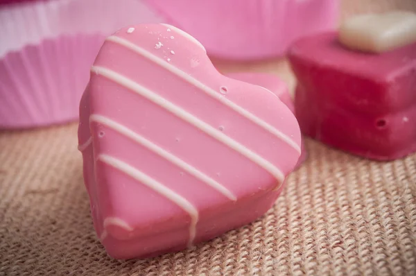 pink shaped heart pastry on hessian texture