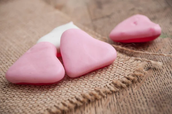 shaped heart candies on wooden background