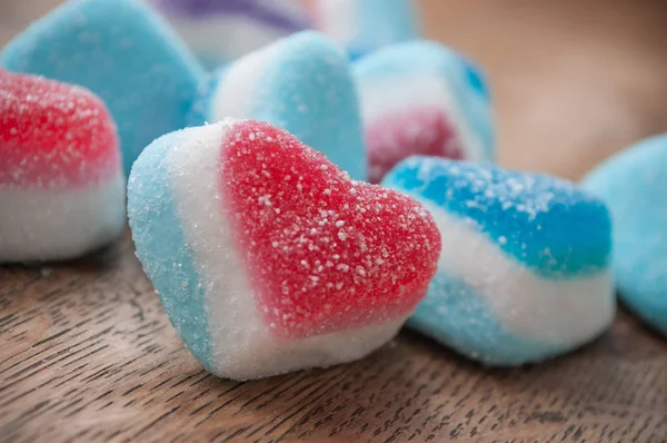 Traditional candies in shaped heart on wooden background — Stock Photo, Image