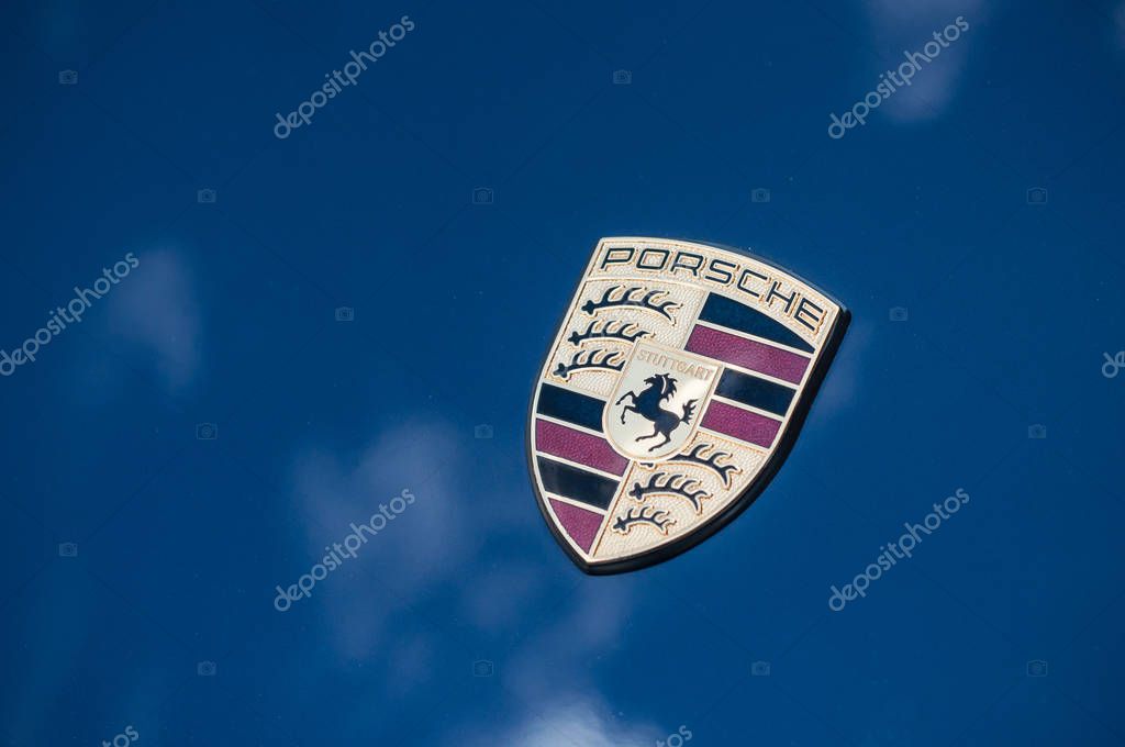 Colmar - France - 7 April 2018 - retail of porsche 911 logo on blue sport car front