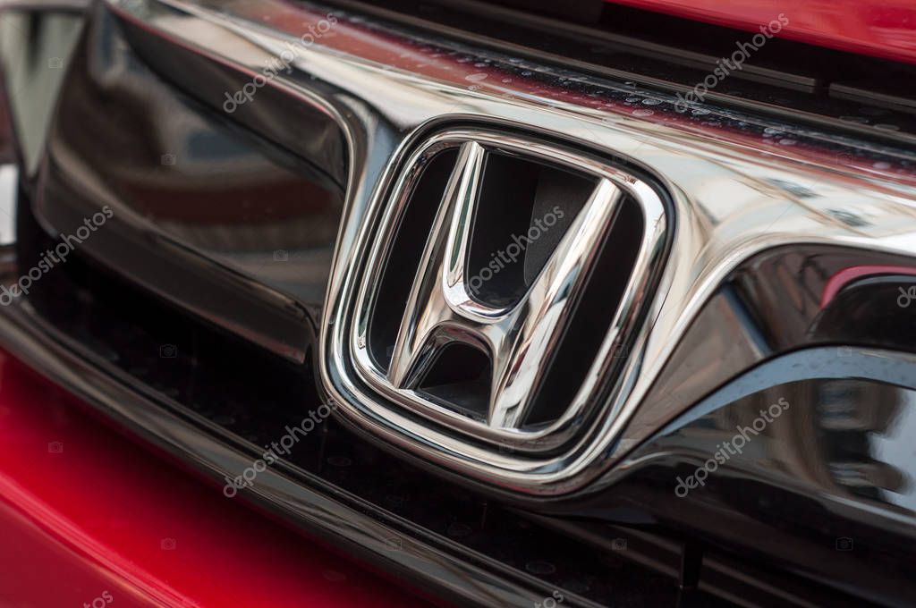 Mulhouse - France - 8 April 2018 - Closeup of Honda logo on red Honda civic car front