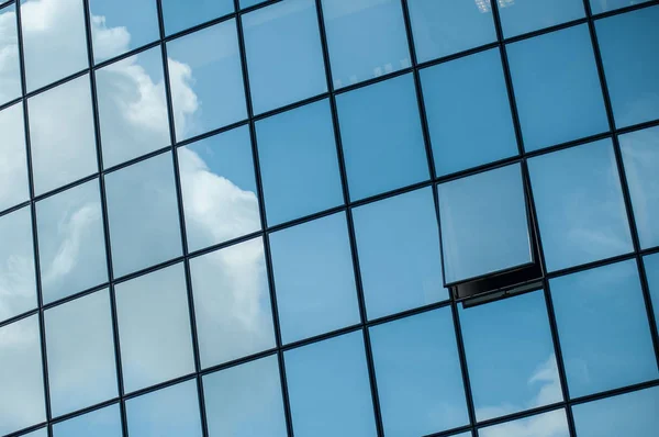 Modern building with glass reflection of clouds — Stock Photo, Image