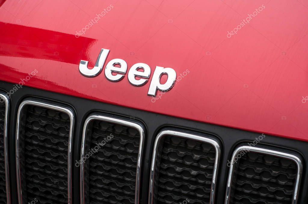 Mulhouse - France - 31 October 2019 - Closeup of Jeep logo on red car front parked in the street