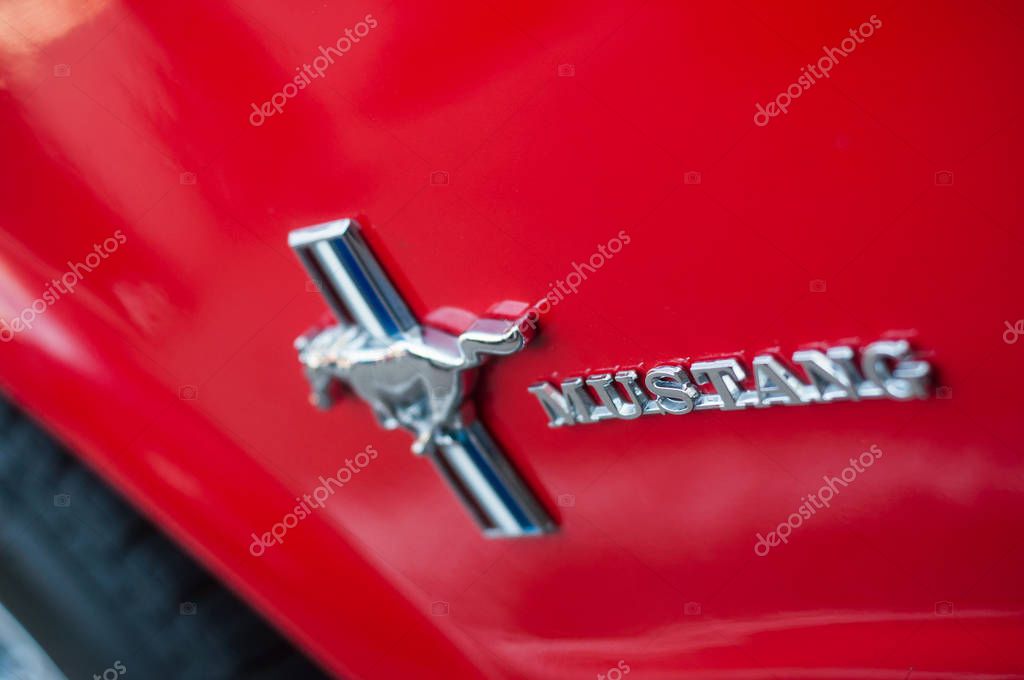 Mulhouse - France - 13 October 2019 - Closeup of logo on red ford mustang door parked in the street