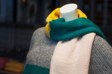 Closeup of woolen pullover and scarf on mannequin