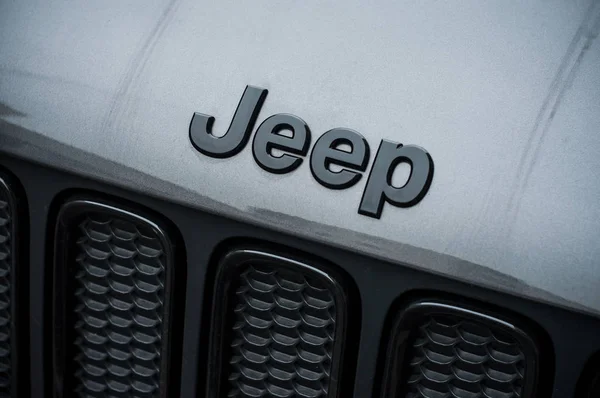 Jeep logo on black car front parked in the street — Stock Photo, Image
