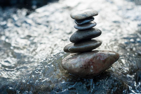 Closeup of stone balance on rocks in the river Stock Picture