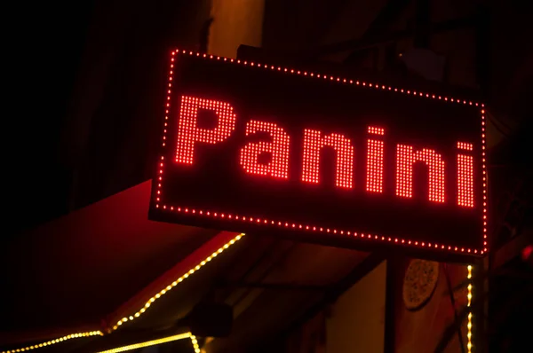 Loseup of illumined panini sign on signboard in the street — Stock Photo, Image
