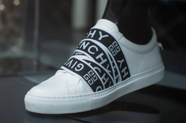 Black and white sneakers by Givenchy in a luxury fashion store showroom — ストック写真