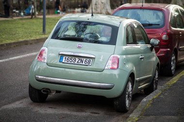  Rear view of green Fiat 500 Parked in the street