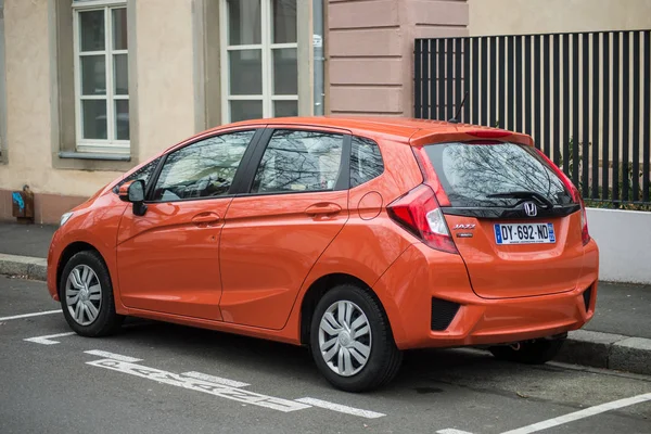 Rückansicht des orangefarbenen Honda Jazz, der auf der Straße geparkt ist — Stockfoto