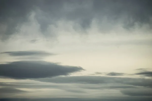 Closeup of grey cloudy sky texture by sunset