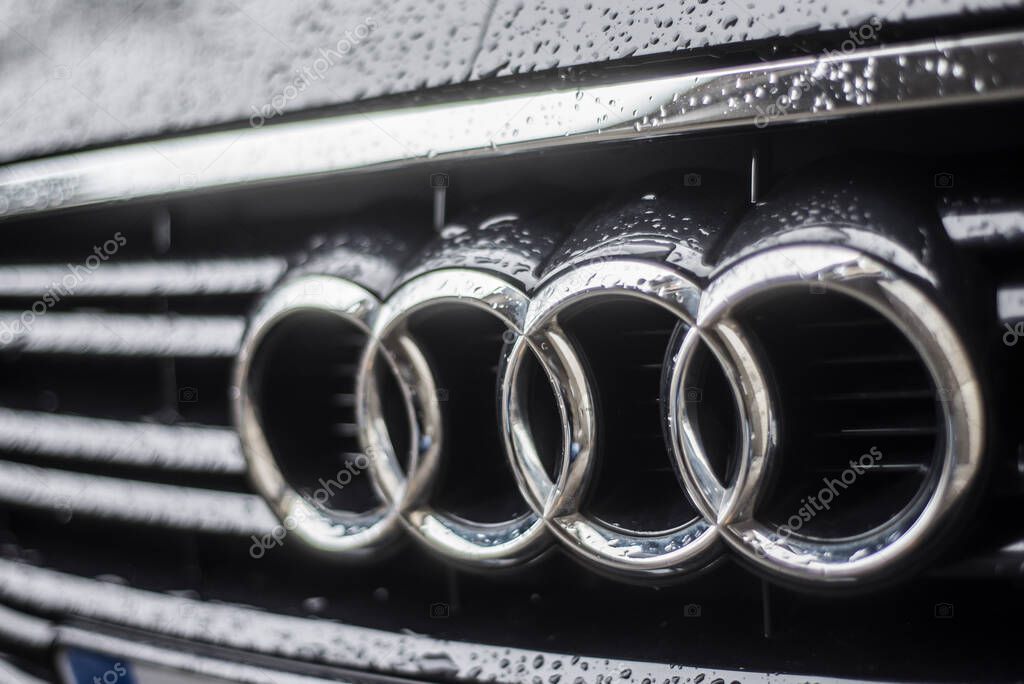 Mulhouse - France - 2 February 2020 - closeup of rain drops on Audi logo on black car parked in the street
