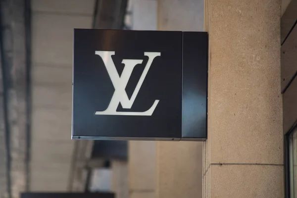 Louis Vuitton logo on signboard on store front in the street — 스톡 사진