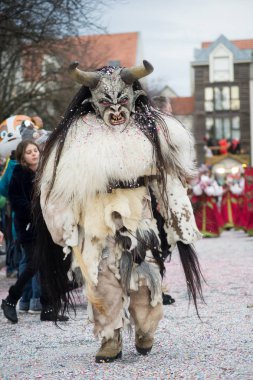 people with scary costume parading in the street 