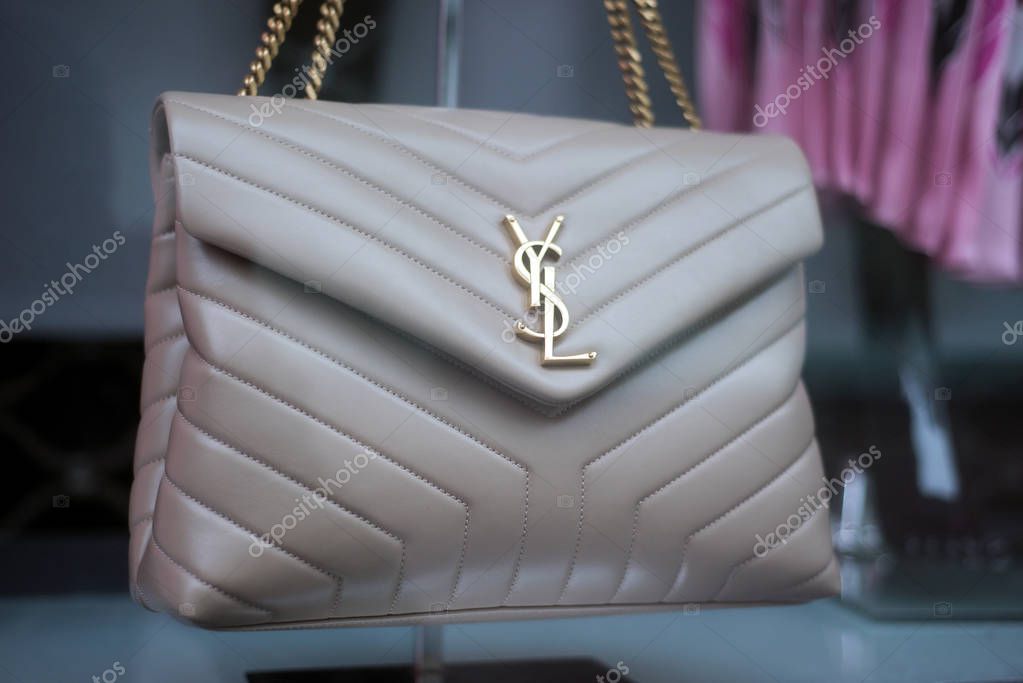 Mulhouse - France - 1 March 2020 - Closeup of brown leather handbag by Yves Saint Laurent in a luxury fashion store showroom