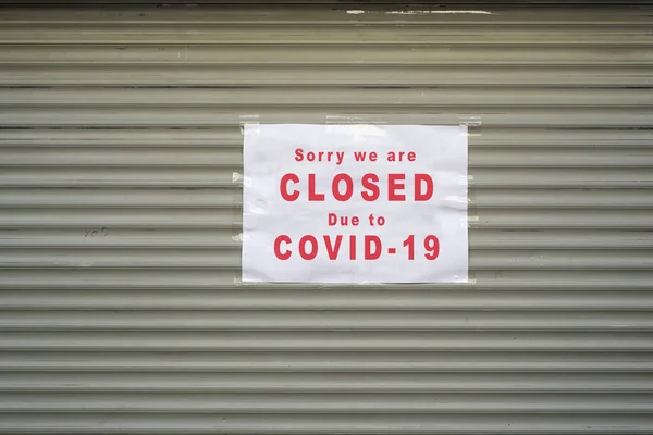 店頭のメタルシャッターに関する情報表示の閉鎖 申し訳ありませんが Covid 19のため閉鎖させていただきます — ストック写真