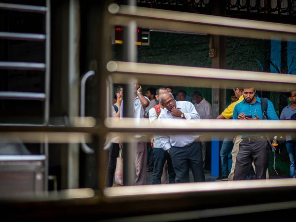 Mumbai, Hindistan - 28 Ekim 2019: Mumbai yerel tren istasyonunda kimliği belirsiz yolcular bekliyor