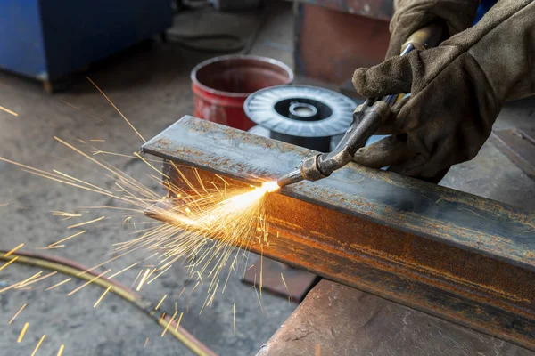 H-beam steel cutting with Hand Gas Cutting Torches, at industrial factory.