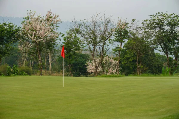 Red flag on Green Golf Course and Green Mountain.