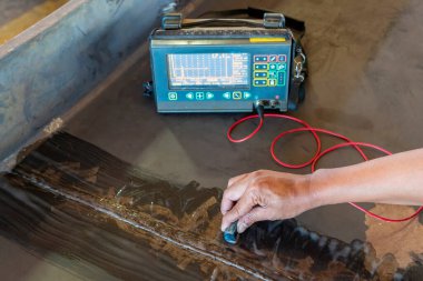 Endüstriyel fabrikadaki yıkıcı olmayan testin (NDT) Ultrasonik test (UT) işlemiyle birlikte çelik eklem eklemindeki arızanın kontrol edilmesi.