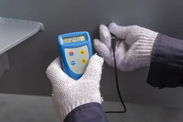 Measure dry film thickness (DFT) with Coating Thickness Gauge for painting on steel structure, at industrial factory.
