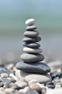 Kumsalda kumsalda gri ve beyaz taşlardan oluşan gevşeme piramidi