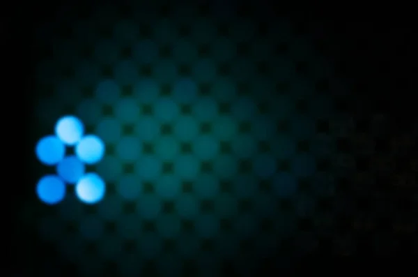 Blue, green circles on a dark background