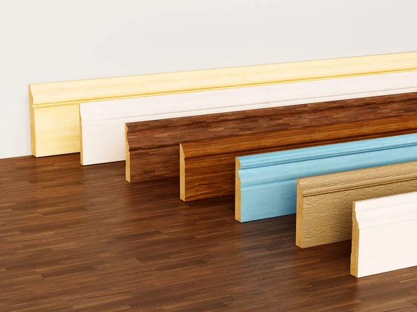 Baseboard con vari profili in piedi su superficie in legno duro. Illustrazione 3D — Foto Stock