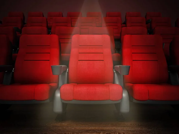 Spotlit red cinema chair in the first row. 3D illustration — Stock fotografie