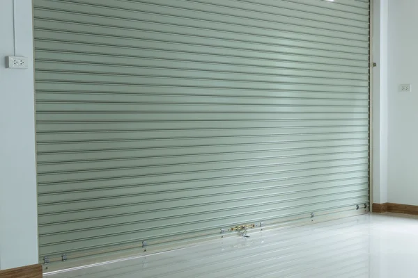 Aluminium steel metal roller shutter door in warehouse building Stock Image