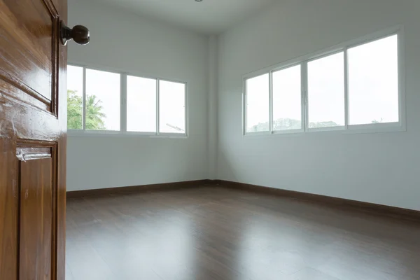 Open wooden door empty white room with window — Stock Photo, Image