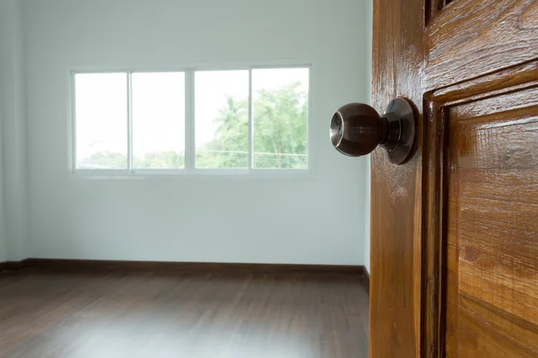 Otevřete dřevěné dveře prázdné bílé místnosti s oknem — Stock fotografie